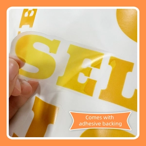 Detail view of the yellow watercolor sun wall decal showing the adhesive backing peeled back