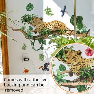 Detail of leopard and tropical leaves wall sticker applied on a white wall