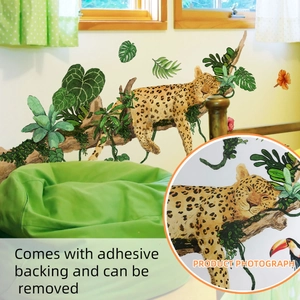 Detail of leopard and tropical leaves wall sticker with adhesive backing shown in bedroom