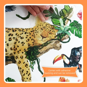 Detail of tropical animal wall sticker with adhesive backing being peeled for easy application