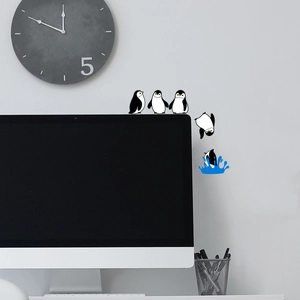 Detail of cartoon penguin wall stickers showing diving poses on a minimalist background