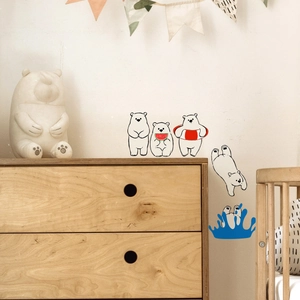 Detail of cute polar bear wall stickers in a warm nursery room with wooden furniture