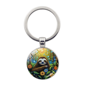 Detail of sloth cartoon art pendant on silver keychain with glass cabochon finish