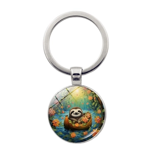 Detailed close-up of a silver keychain featuring a cute sloth illustration in a glass cabochon