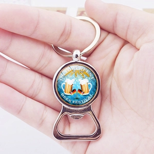Oktoberfest beer mug and German flag metal keychain bottle opener held in hand