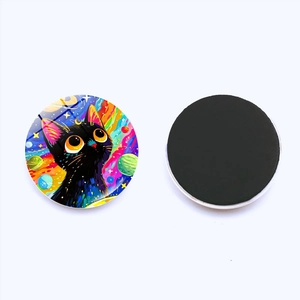 Detail of round crystal glass fridge magnet featuring a colorful starry cat digital illustration