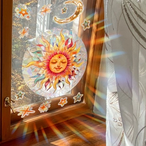 Rainbow suncatcher window sticker with sun moon stars design on glass surface