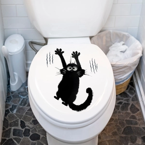 Funny black cat wall sticker showing a cartoon kitten scratching a white toilet lid cover