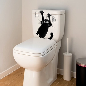 Funny black cat wall sticker showing a climbing kitten silhouette on a toilet tank