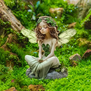 Garden fairy figurine with green wings sitting on stone amidst lush forest moss scenery