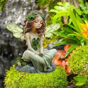 Green fairy garden statue with wings sitting on rock, whimsical forest garden outdoor decor