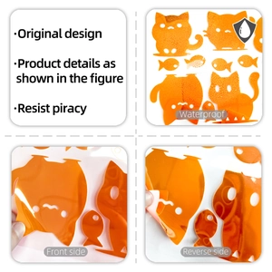 Detail of waterproof orange cartoon cat and fish wall stickers showing glossy finish
