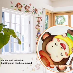 Detailed view of monkey and butterfly wall stickers with self-adhesive backing
