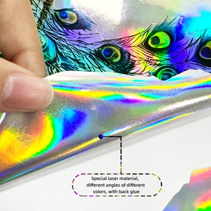 Detailed close-up of a holographic peacock feather sticker with color-changing laser finish