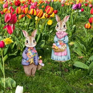 Retro bunny couple garden stakes among tulips for outdoor Easter yard decoration