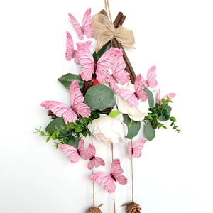 Detail of 3D pink butterfly wall decor with realistic wing textures and rustic wooden frame