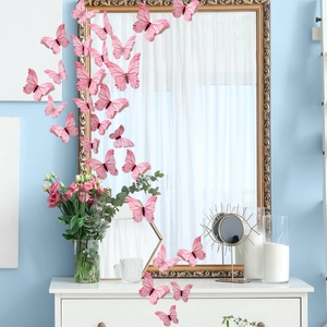 Detailed view of 3D pink butterfly wall stickers with realistic textures on a blue wall