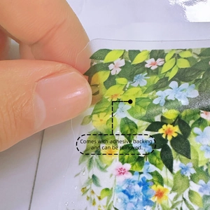 Close-up of floral wall sticker showing the adhesive backing and removable transparent film