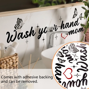Detail of black 'Wash your hands' wall decal with butterflies on bathroom mirror