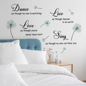 Inspirational butterfly and dandelion wall stickers above a bed in a bedroom setting