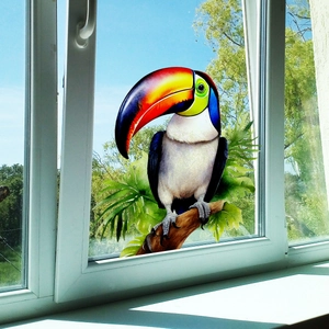 Tropical toucan and green leaf static window film decor on a glass window frame