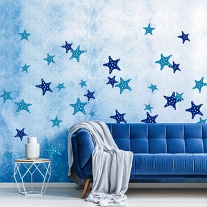 Blue ocean starfish wall stickers with polka dots above a navy velvet sofa decor
