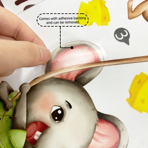 Detail of self-adhesive cartoon mouse wall sticker showing flexible material and easy removal