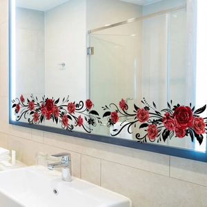 Close-up of red rose and black vine floral window stickers on a bathroom mirror