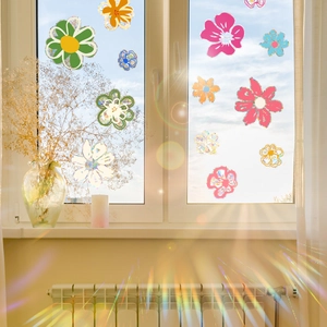Colorful daisy glass window stickers with rainbow light refraction in sunlight
