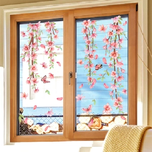 Pink cherry blossoms and butterfly static window clings on glass with blue sky background