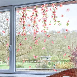 Detailed view of pink peach blossom and butterfly static window stickers on clear glass