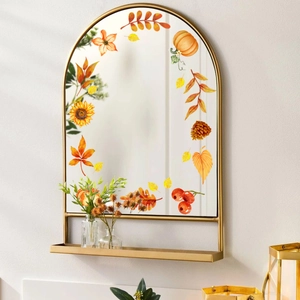 Detailed close-up of autumn sunflower and pumpkin window stickers on an arched mirror