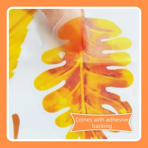 Detail of self-adhesive autumn leaf wall sticker showing translucent material and backing