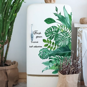 Detail of tropical monstera leaf stickers on a white fridge in Nordic style home decor