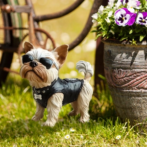 Yorkshire terrier garden stake with sunglasses and punk vest on outdoor lawn