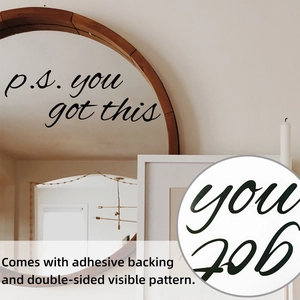 Detail of self-adhesive wall sticker with 'p.s. you got this' quote on a round mirror