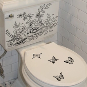 Minimalist black floral and butterfly waterproof stickers on a white toilet