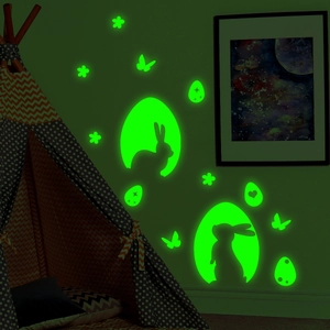 Luminous Easter bunny and eggs wall decals glowing green in a dark children's room