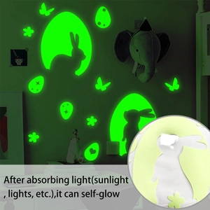 Detailed view of glow-in-the-dark Easter bunny and egg wall stickers in green light