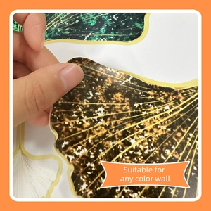 Close-up of peeling creative golden ginkgo leaf wall sticker for any color wall surface