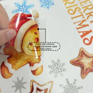 Double-sided gingerbread man window sticker showing adhesive backing and clear detail