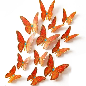 Detailed set of 12 orange and gold butterfly wall stickers with blue rhinestone accents