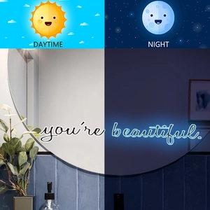 Luminous wall mirror with inspirational text showing day and night glow effect