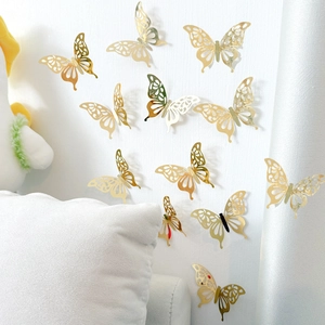 3D metallic gold butterfly wall stickers with hollow patterns on white wall decor
