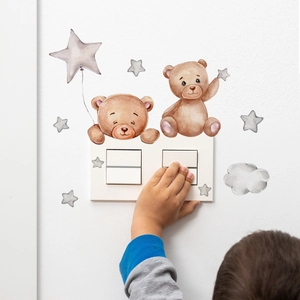 Watercolor cartoon bear and star wall stickers decorating a white light switch panel