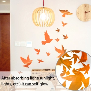 Luminous orange flying bird wall stickers showing 3D glowing effect in home bedroom