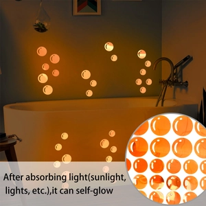 Close-up of orange bubble wall stickers showing self-glow effect in bathroom setting