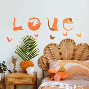 Detail of creative orange gradient cat love wall stickers and butterfly decals in a bedroom