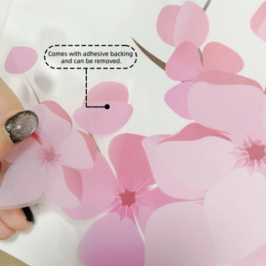 Detail of pink blossom wall sticker showing translucent texture and removable adhesive
