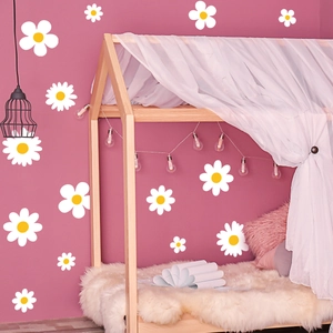 Charming white daisy flower wall decals in various sizes on a soft purple interior wall